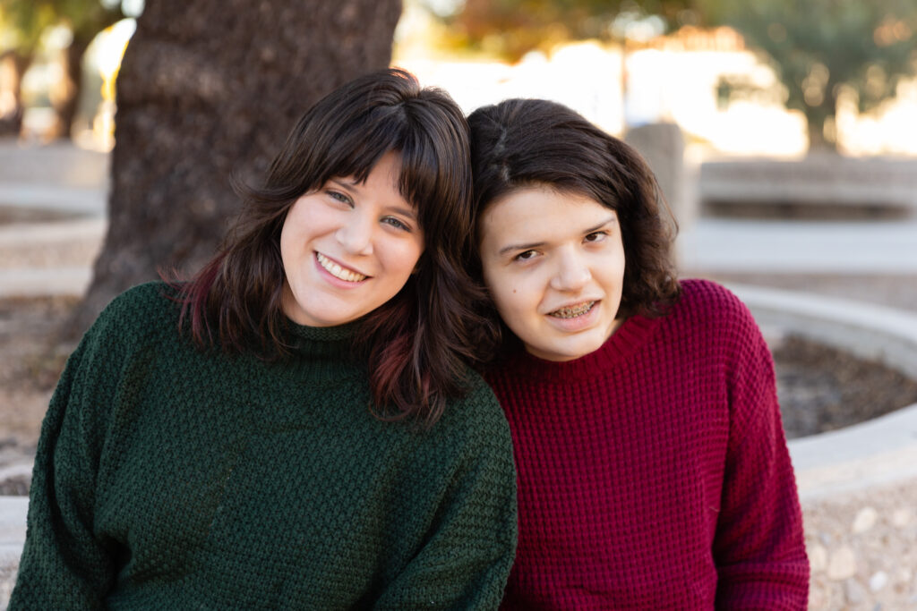 Sisters posing together during a sister session in Downtown Tucson. Katie Gilbert Photography.