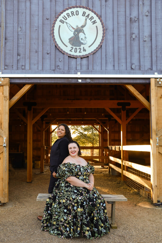 Couple sitting on a bench in a barn at a lavender farm. 